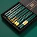 Set of green chopsticks with gold accents in a black box on a green background