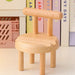 Mini chair mobile holder placed near pastel books and pink crate – functional desk accessory with clean aesthetic – 1598453326009 13953547