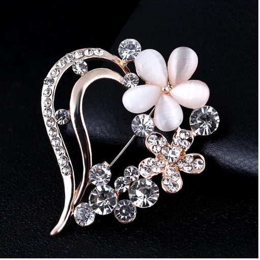 Digital Shoppy opal brooch – dual-flower design with opal petals and rhinestone blossom, placed on black surface

