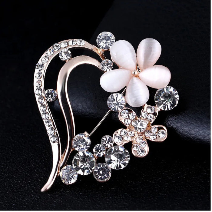 Digital Shoppy opal brooch – dual-flower design with opal petals and rhinestone blossom, placed on black surface

