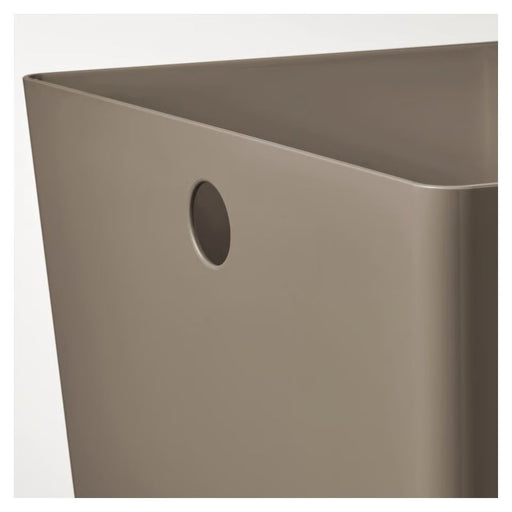 Beige metal bin with a circular hole on a white background