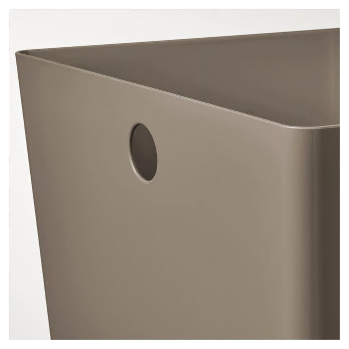 Beige metal bin with a circular hole on a white background