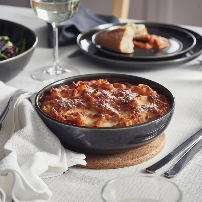 GLADELIG oven dish filled with baked lasagna, placed on a white tablecloth with wine, salad, and bread for a cozy dinner setting70607948