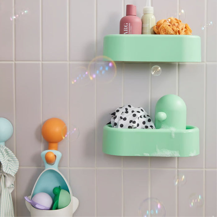 HUMLESJÖN basket used to organize bath toys and hygiene items in a playful, pastel-themed bathroom.

