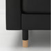 Close-up of an IKEA LANDSKRONA Leg, wood, 15 cm 5 7/8 inches, attached to a black upholstered furniture piece—showcasing the sturdy wooden base and modern design for enhanced stability and style -50292398.
