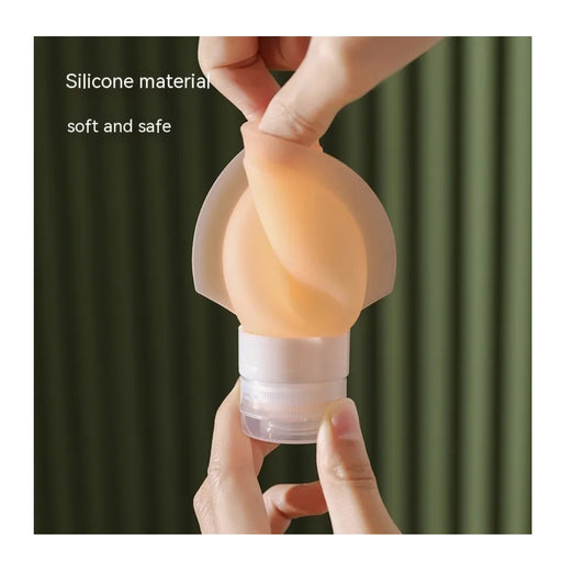Silicone product held by hands with text 'Silicone material soft and safe' on a green curtain background