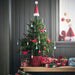 Fully decorated IKEA VINTERFINT mini Christmas tree with red hearts and colorful ornaments on a wooden table.