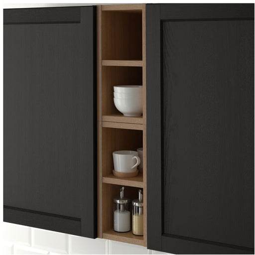 Black kitchen cabinet with wooden interior shelves containing cups and jars.