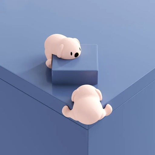 Soft silicone corner guards in a playful pink bear design. Ideal for childproofing tables and furniture edges. Strong adhesive for secure attachment. Pack of 4.