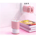 Pink and white cable reel with a wall outlet in the background
