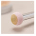 Makeup brush with pink and beige bristle head on a light background