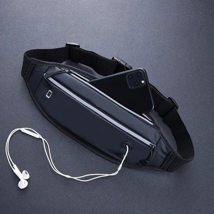 Black waist bag with phone and earbuds on a dark gray background