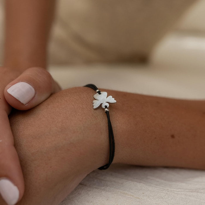 Couple Angel Bracelet – Adjustable Wax Cord, Stainless Steel Charm, worn on wrist with light pink nails