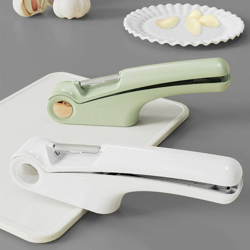 Digital Shoppy Green and white garlic presses placed beside peeled garlic cloves and bulbs