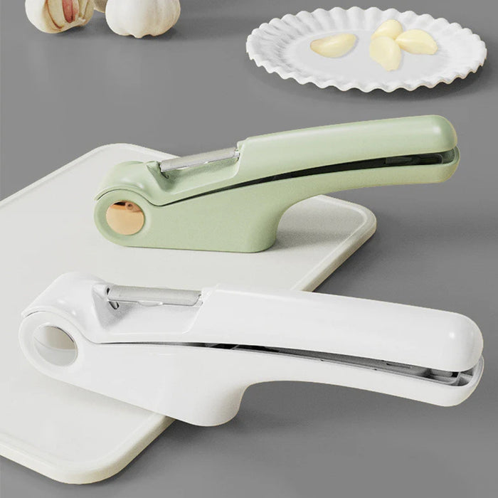 Digital Shoppy Green and white garlic presses placed beside peeled garlic cloves and bulbs