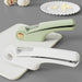 Digital Shoppy Green and white garlic presses placed beside peeled garlic cloves and bulbs