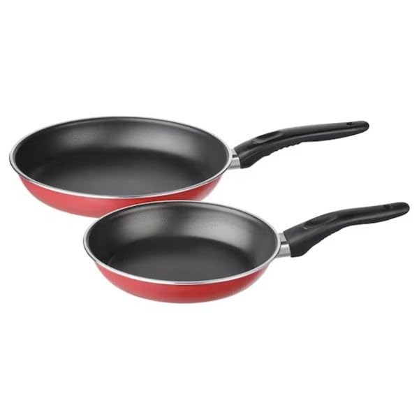 Two red frying pans with black handles on a white background