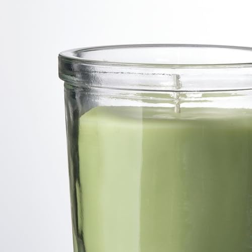 Close-up of unused green candle in clear glass with thick rim and base – 50582053
