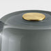 Gray container with a gold lid on a light gray background