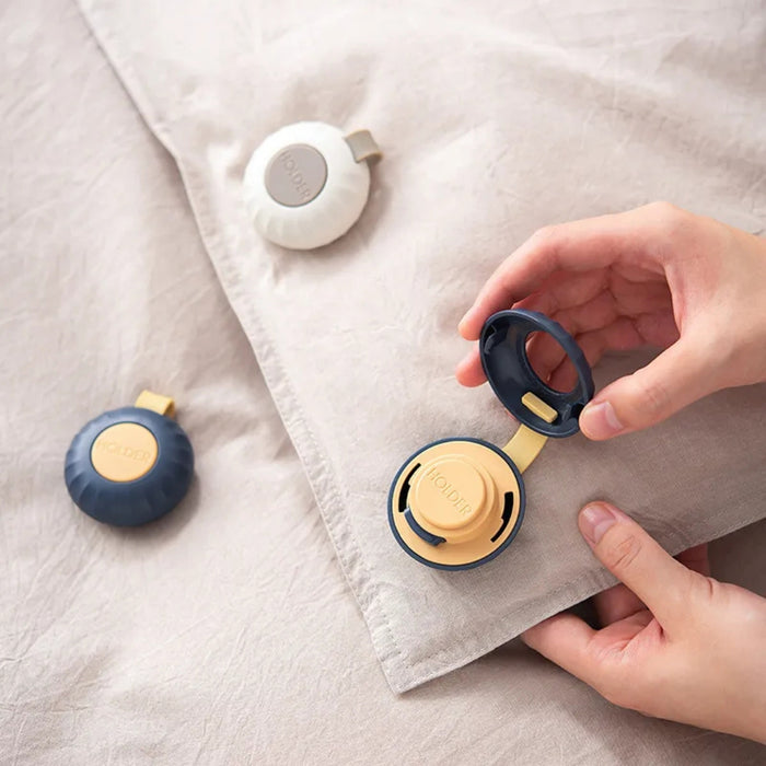 Small round devices with black and yellow accents on a textured surface.