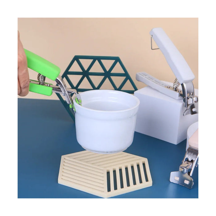 Handheld kitchen mixer with attachments on a blue surface