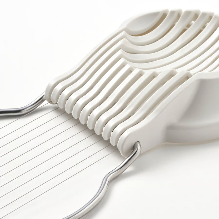 IKEA UPPFYLLD Egg slicer, off-white, featuring a durable plastic base with multiple parallel stainless steel cutting wires for clean, uniform slices. The compact design ensures easy handling, while the sturdy grooves align perfectly for smooth cutting.-40605125