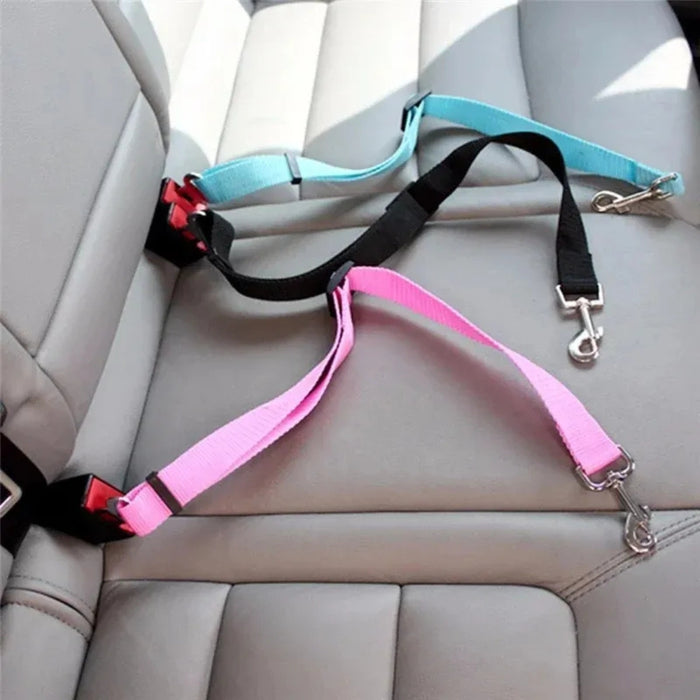 Digital Shoppy Pink and blue pet seat belt harnesses clipped into car seat buckles with metal leash hooks