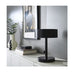 Black table lamp on a white surface with a neutral background