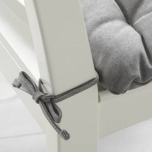 Gray checkered fabric draped over a white surface with a knot.