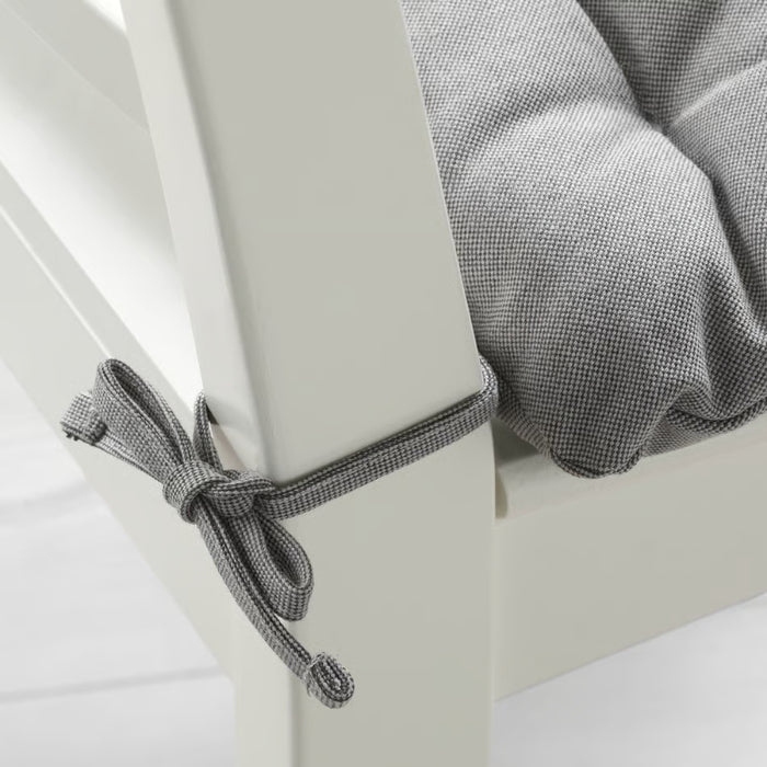 Gray checkered fabric draped over a white surface with a knot.
