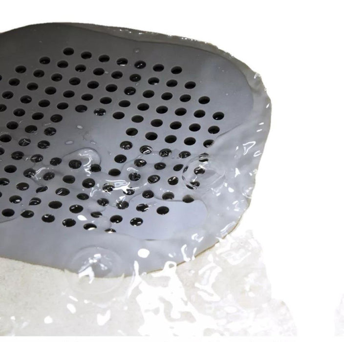 Fine mesh filter in silicone drain stopper – blocks hair while allowing water drainage.
