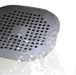 Fine mesh filter in silicone drain stopper – blocks hair while allowing water drainage.
