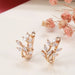 Rose gold wheat earrings – placed on glossy surface with dried flowers for elegant styling