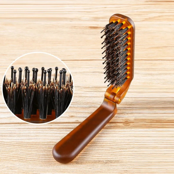 Brown hairbrush with close-up of bristles on a wooden background