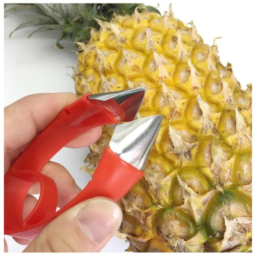 Pineapple peeler being used on a pineapple