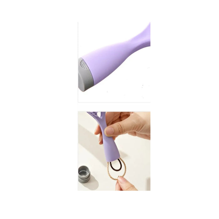 Purple handheld device with a ring attachment held by a hand on a white background
