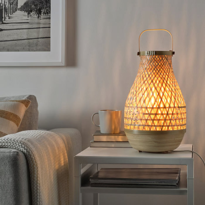 Woven table lamp on a side table with a cozy living room setting