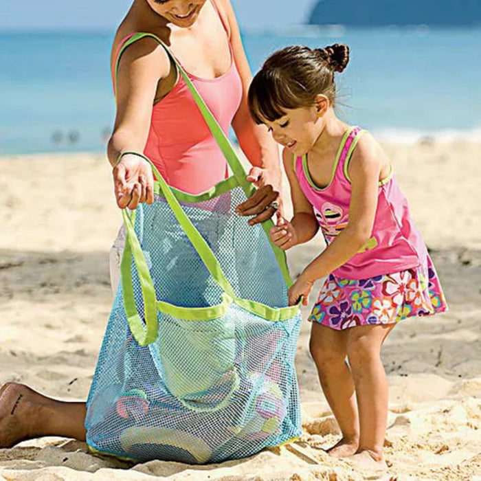 Woman and child on a beach with a mesh bag