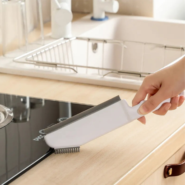 Person using a kitchen cleaning brush under a sink