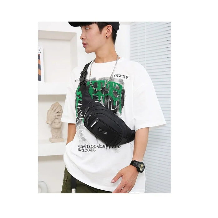 Person wearing a white t-shirt with graphic design and carrying a black waist bag.