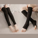 Two individuals wearing black textured leg warmers seated on soft white surface - 