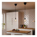 Modern kitchen with pendant lights, wooden countertop, and white cabinets.