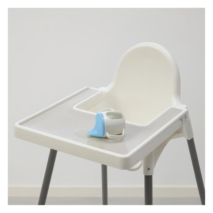White high chair with a blue and gray cup holder on a light gray background