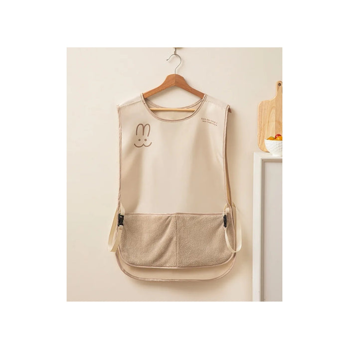 Beige apron with a cartoon bunny design on a hanger against a light background