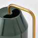 Close-up of VATTENKRASSE watering can showing conical body, irregular top opening, and angular gold handle detail