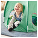 Child playing with a green play tent on a carpeted floor
