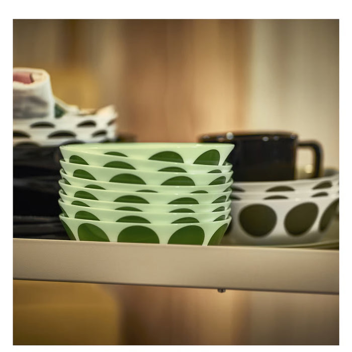 Stack of green patterned bowls on a kitchen counter