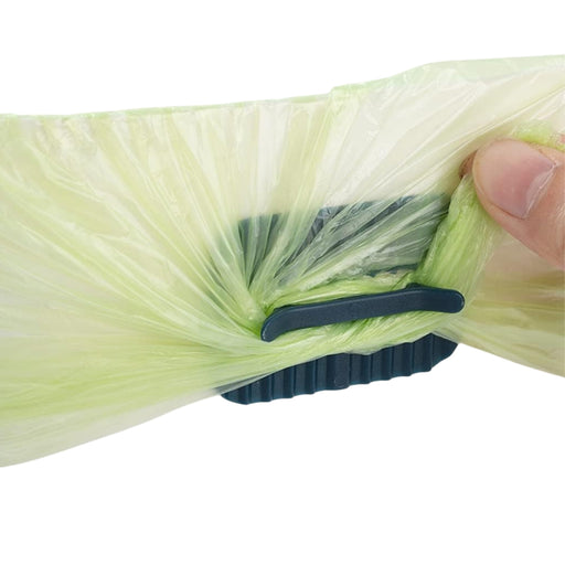 Digital Shoppy 4 Anti-slip Fixers For Household Garbage Bags, hand demonstrating clip sealing green plastic bag