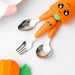 Children’s carrot-themed tableware set featuring a stainless steel fork, spoon, and serrated spoon with orange handles shaped like smiling carrots with leafy green tops—utensils are placed inside an orange carrot-shaped holder with matching cartoon face and green lid; adjacent is another carrot-shaped accessory—playful, kid-friendly design perfect for baby meals – 1600002332714 12850097.