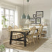 Dining room with two RÖDFLIK pendant lamps in grey-green hanging above wooden table, styled with vase of flowers and Scandinavian decor